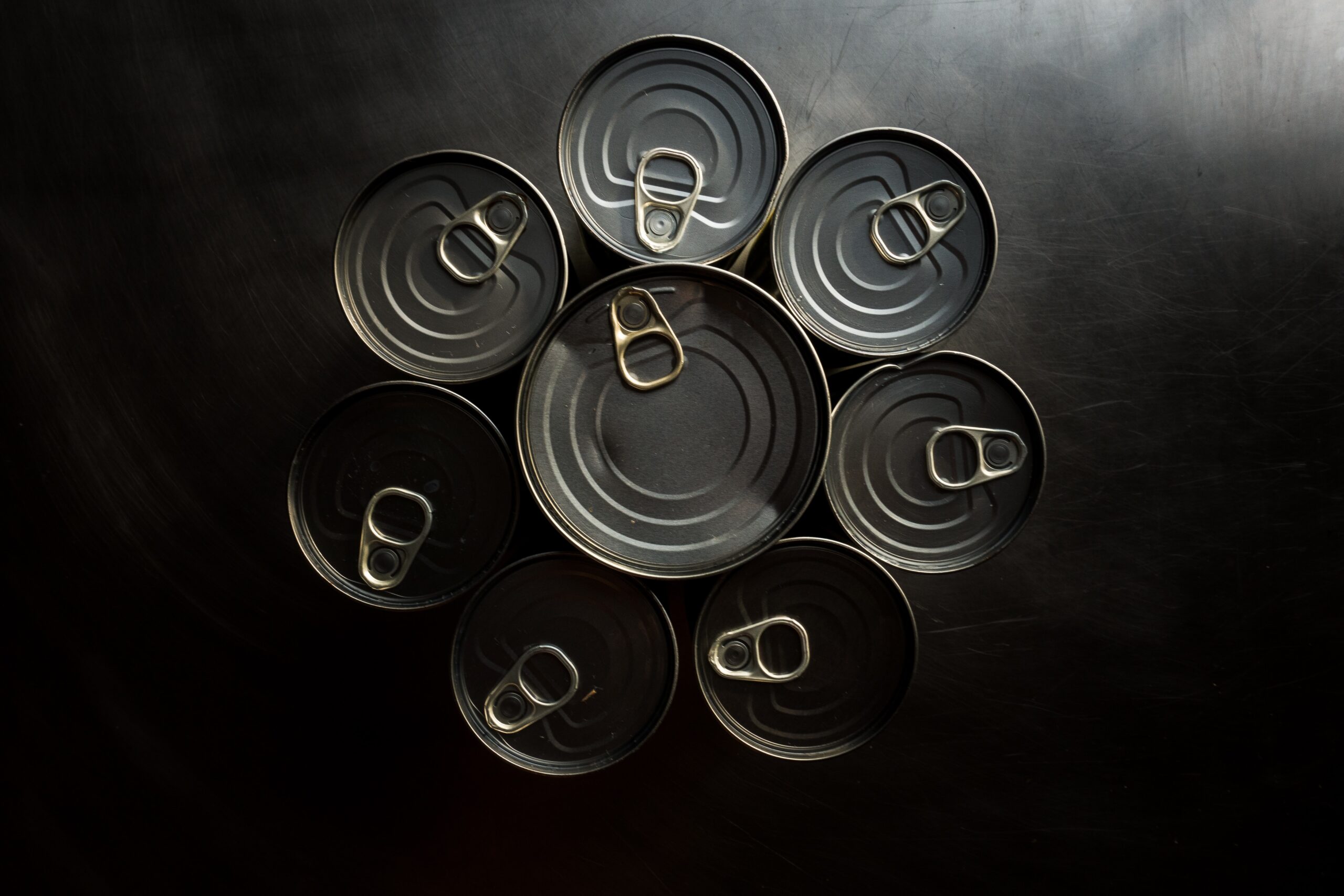 tops of steel food cans with pull tabs